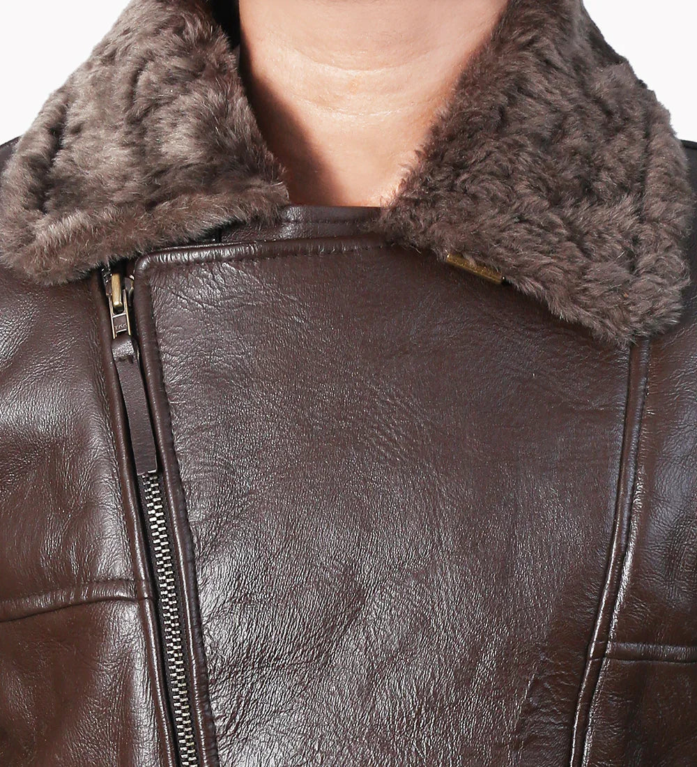 Close-up of distressed brown leather jacket with shearling collar and metal zipper